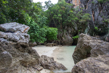 Small bay surrounded by intricate limestone,soft white sand beach and emerald color sea at Lading island(Paradise island) in Krabi province,Southern Thailand.