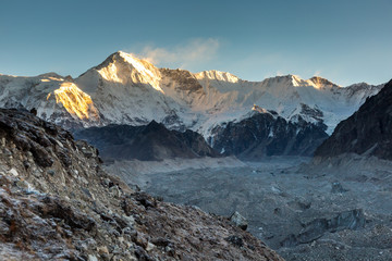 Ngozumpa glacier and Cho Oyu mount in a sunrise light, a border between Nepal and Tibet, view from Gokyo valley. 