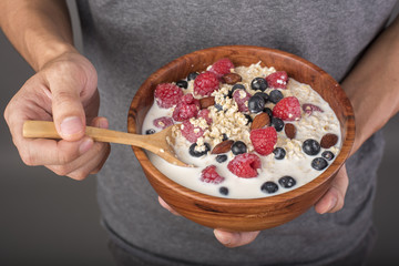 Healthy breakfast ingredients in man hand, Healthy food concept