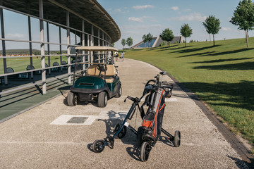 Empty golf cart and golf clubs in bag on walkway