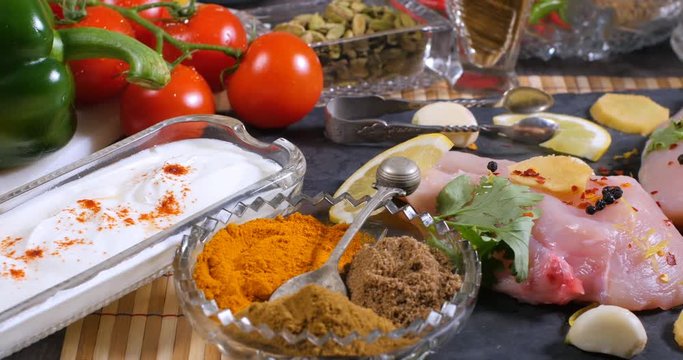 Dolly view of ingredients and indian spices for chicken tikka masala