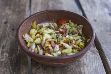 Fresh, vegetable salad on wooden table