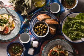 Dinner with traditional Greek dishes on the white table top view