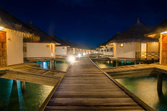 A night scene of sea bungalows at Maldives