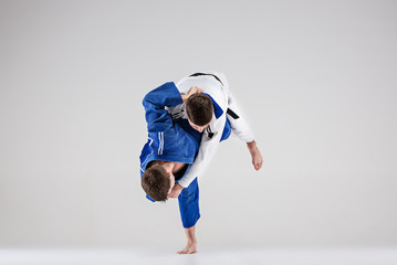 The two judokas fighters fighting men