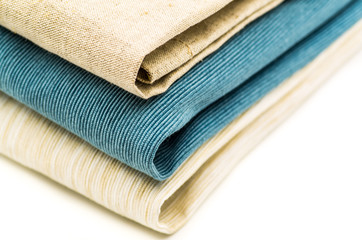 three linen table mats on white