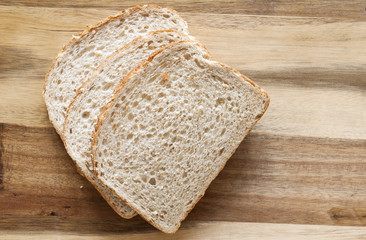 Sliced bread on wooden background from above. 