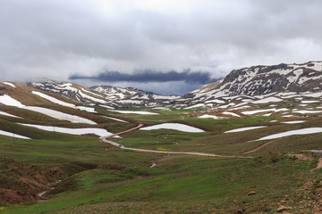 mountains covered by melting snow