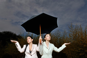 2 women under an umbrella