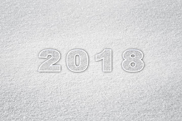 Happy new year 2018 celebration message on the sunny fresh snow.