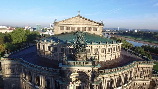 Aerial of historical opera "Semperoper" in the baroque city center of Dresden, Germany - drone view over the city in sunset