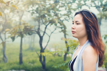 Portrait of a beautiful happy girl on the park and fog in the morning