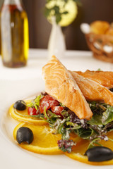 Salmon with vegetables arranged on a plate, Traditional dish in elegant setting, Selectiv focuse with soft light
