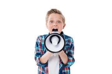 Cute little boy screaming in megaphone and looking at camera