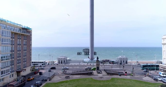 Aerial ascending view of a regency square in Brighton and Hove approaching the sea and the destroyed west pier