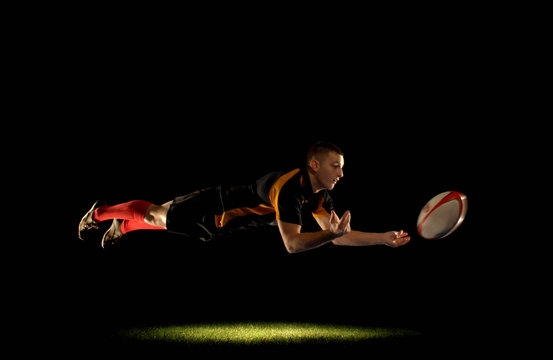 Rugby player diving and passing