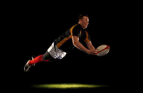 Rugby player diving an throwing ball - Powered by Adobe