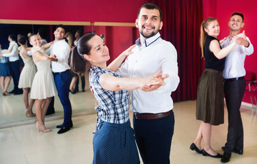 People learning to dance waltz in dancing class