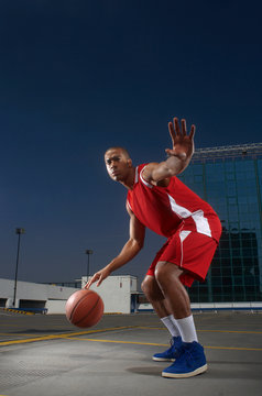Basketball Player Dribbling On Rooftop
