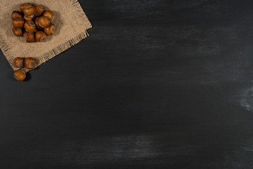 Hazelnuts  on a black chalkboard.