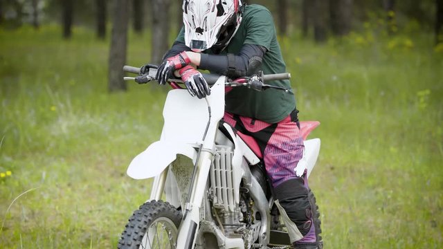 Biker on enduro bike at the forest. Man rider standing and waiting