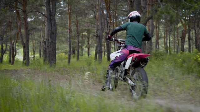 Cross bike in action. Biker riding in the forest. Off-road riding