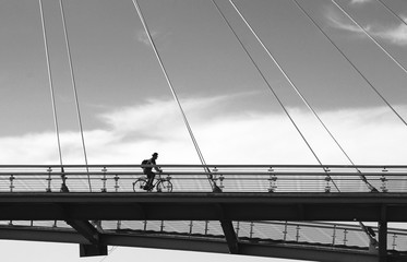Naklejka premium cyclist on a bridge