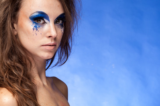 Woman with blue creative make up in studio photo
