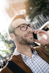 Trendy businessman in Manhattan talking on phone