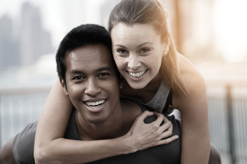 Man giving piggyback ride to girlfriend