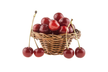 Cherries in a wicker basket isolated on a white background