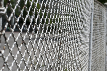 Old vintage painted metal fence mesh photographed at acute angle