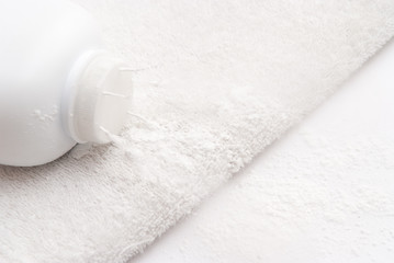 talcum powder on a soft white towel background