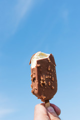 Biten ice cream against blue sky.