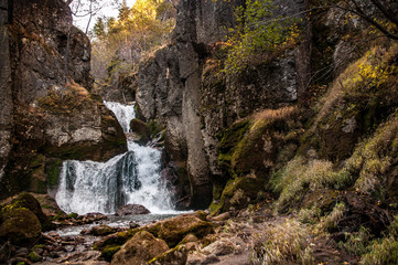 Waterfall and big stone cliff