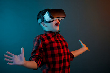 Gesturing kid in glasses of virtual reality