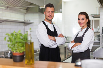 Two smiling chefs in kitchen
