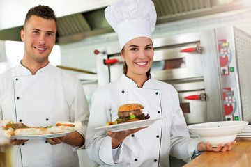 Two smiling chefs in kitchen
