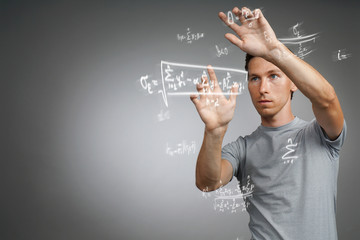 Man scientist or student working with various high school maths and science formulas.