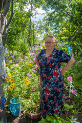 Happy older women in garden with flowers