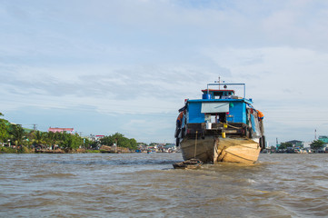 Fototapeta na wymiar Wooden cargo boat on the Mekong River Delta