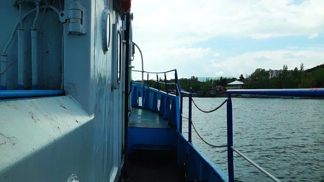 Floating on old ship along a lake