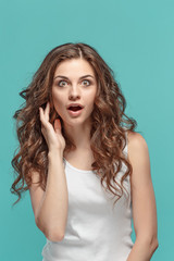 Portrait of young woman with shocked facial expression