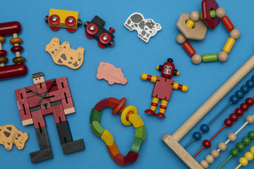 kids wooden toys scattered on blue background