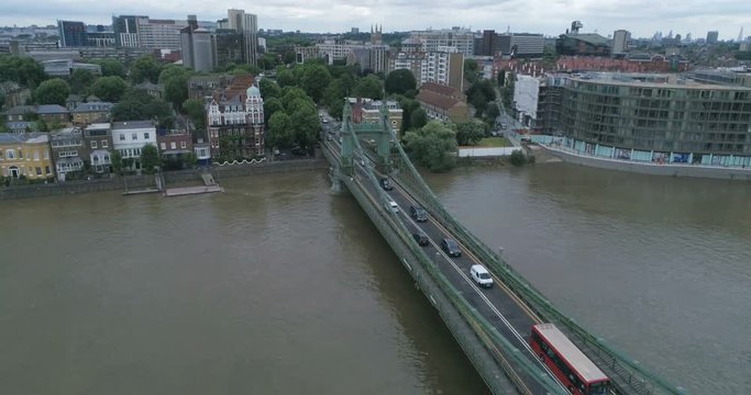 Aerial descending view of Hammersmith bridge and the river Thames in West London