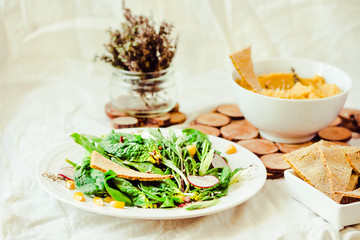 Green salad with arugula, corn, carrots and baked chickpeas.Healthy vegetarian meal concept.