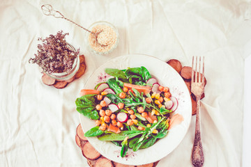 Green salad with arugula, corn, carrots and baked chickpeas.Healthy meal concept. Toning.