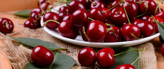 Ripe cherries on wooden table