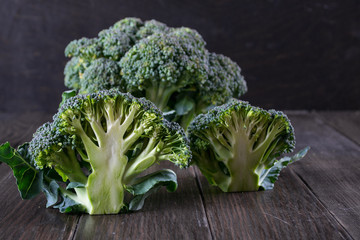 Fresh green garden broccoli on dark wooden background