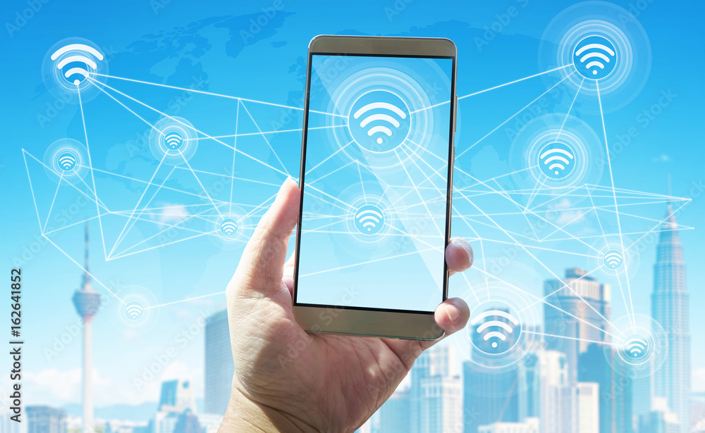 Poster unknown guy using smartphone with smart city and wireless communication network background .